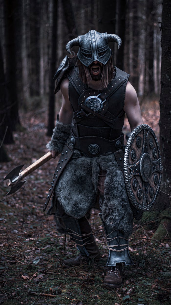 A fierce Viking warrior in detailed armor, holding an axe and shield, standing in a dense forest.